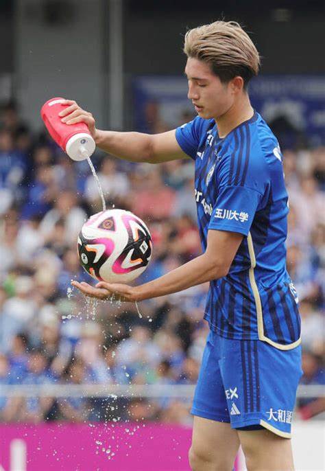 A player pouring water on a ball